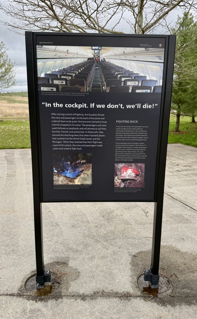 Informational sign about flight hijacking with a caption "In the cockpit. If we don't, we'll die!" featuring a photo of an airplane interior and details about the passengers' actions during the event.