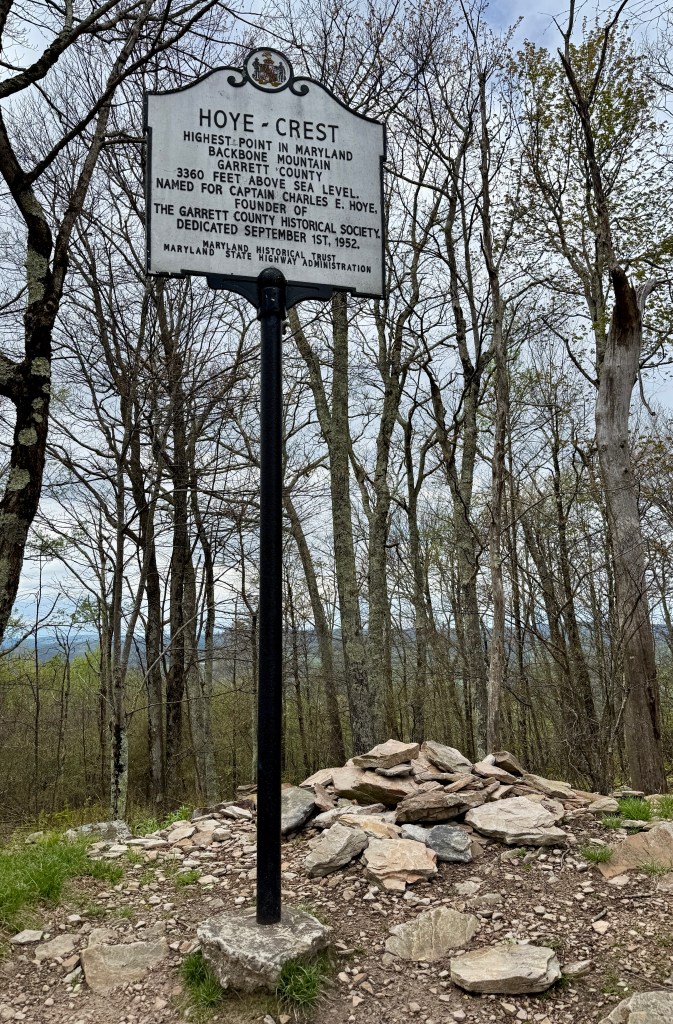 Historical marker for Hoye Crest, the highest point in Maryland, located on Backbone Mountain in Garrett County, noting its elevation of 3360 feet above sea level and dedication date.